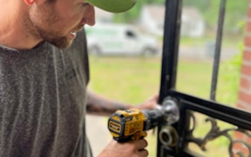 The Lockman employee fixing a lock on a door.