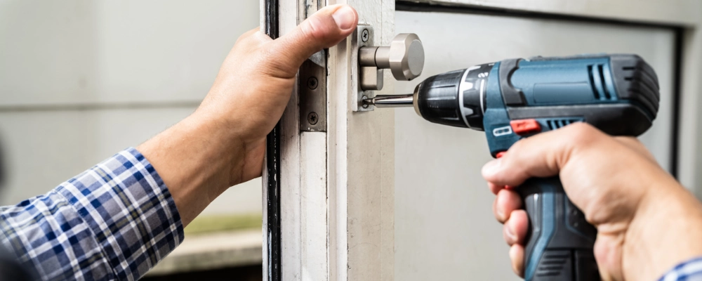 Locksmith installing a lock.