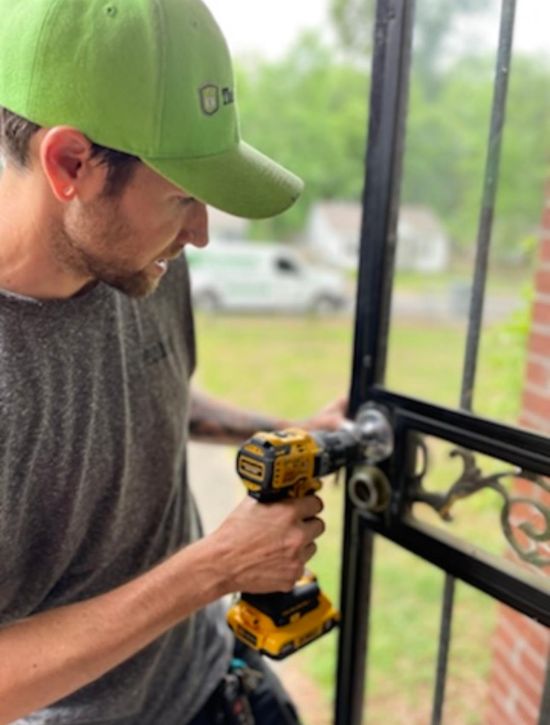 The Lockman employee fixing a lock on a door.