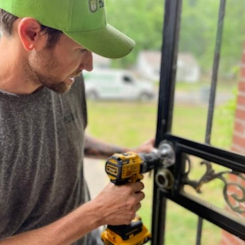 The Lockman employee fixing a lock on a door.