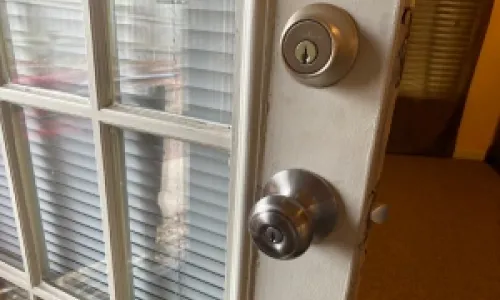 The Lockman employee fixing a lock on a door.